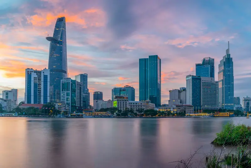 The Bitexco Financial Tower reflected in the Saigon River at sunset