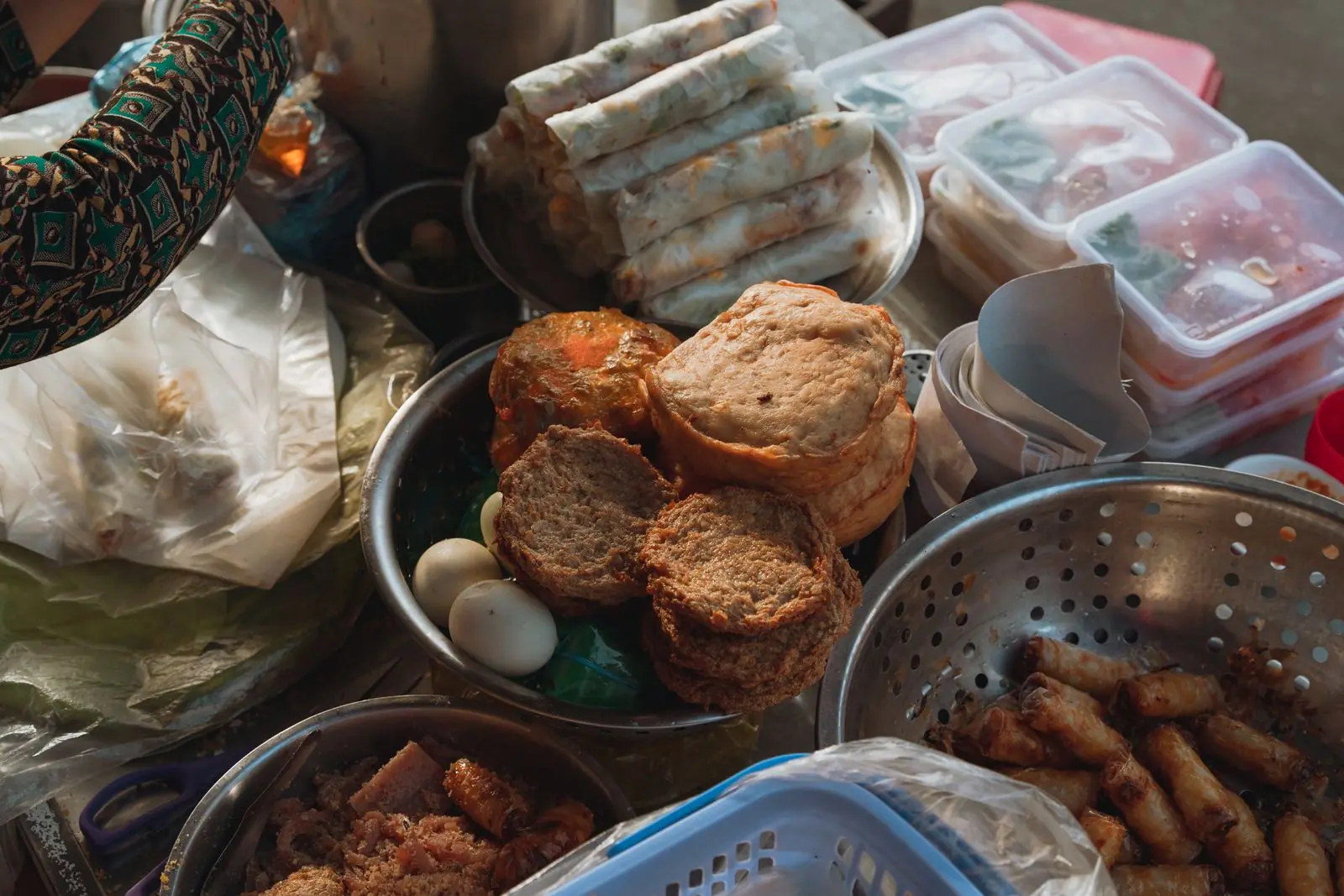A Vietnamese street-food market stall with traditional snacks laid out, in the former Bình Thuận province