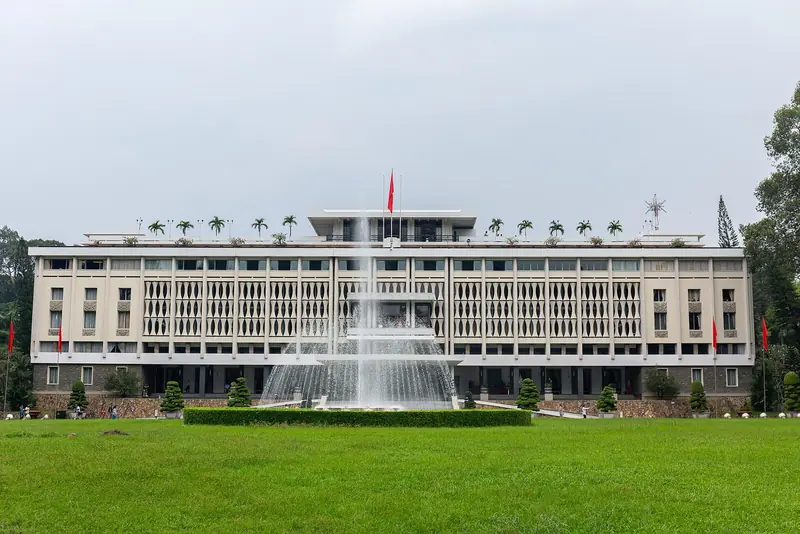 The front of Independence Palace across its lawn and fountain